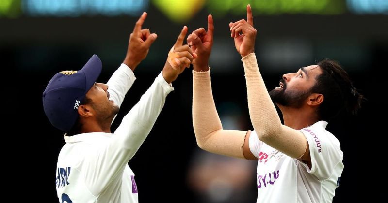 Mohammed Siraj celebrates with Mayank Agarwal after picking up a wicket