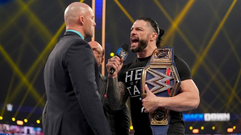 Roman Reigns and Adam Pearce