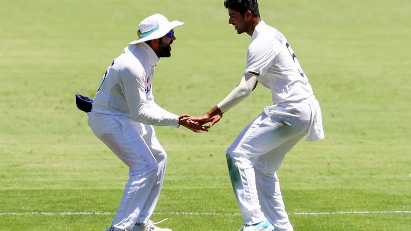 Washington Sundar (R) celebrates with Rohit Sharma after dismissing Steve Smith