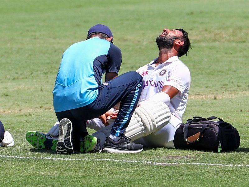 Cheteshwar Pujara receives treatment after being hit. Pic: Twitter