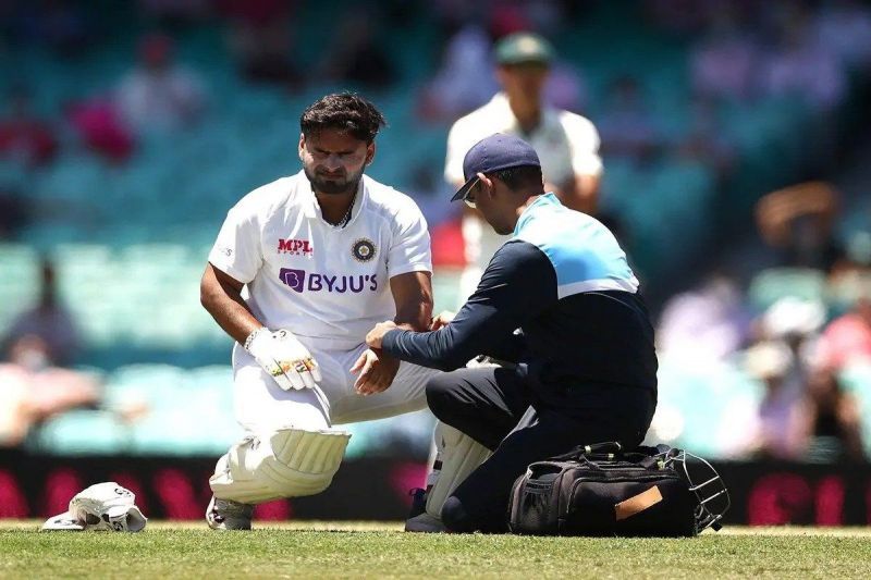 Rishabh Pant getting medical attention after being struck on the elbow