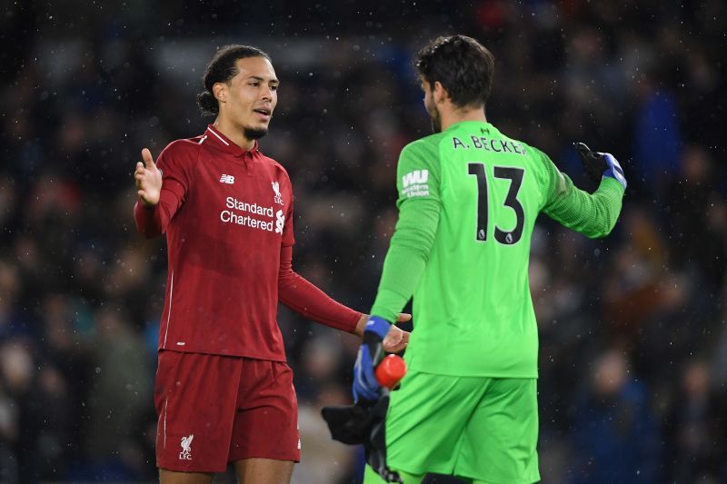 Virgil van Dijk (L) and Alisson Becker