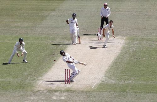 Cheteshwar Pujara ducks a bouncer from Pat Cummins.