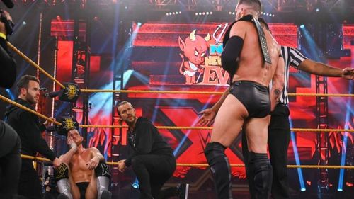 Finn Balor looks on as Undisputed Era consoles Kyle O'Reilly