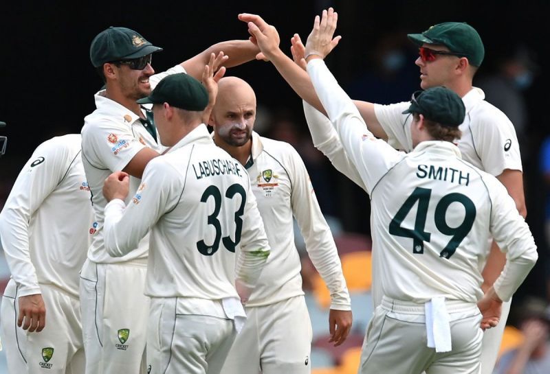 Nathan Lyon celebrates with his teammates after dismissing Rohit Sharma