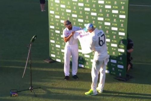 Ajinkya Rahane presents Nathan Lyon the signed jersey