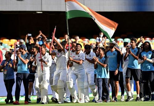 Indian players celebrate with the Tricolor after their historic win at the Gabba