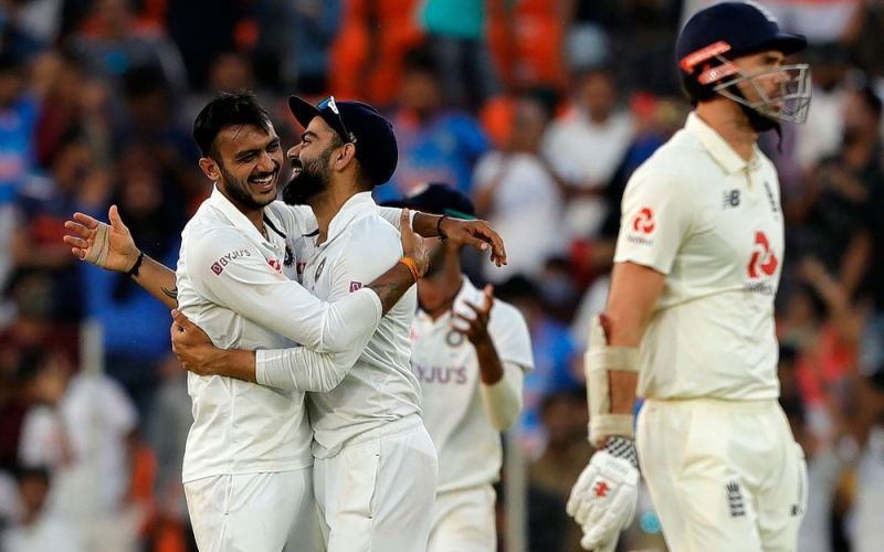 Indian captain Virat Kohli celebrates with left-arm spinner Axar Patel