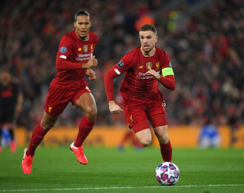 Liverpool&#039;s Virgil van Dijk (L) and Jordan Henderson