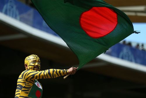 A Bangladesh cricket fan waves the national flag