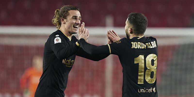 Antoine Griezmann celebrates with Jordi Alba in Barcelona&#039;s 5-3 win over Granada