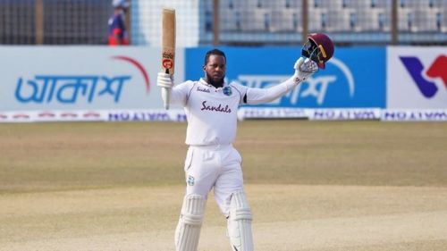 Kyle Mayers celebrating after reaching his century