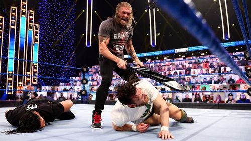 Edge menacingly attacked Daniel Bryan and Roman Reigns