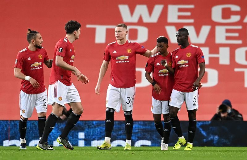 Manchester United players celebrate after opening the scoring against AC Milan