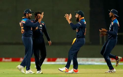 Rohit Sharma celebrates the wicket with his teammates