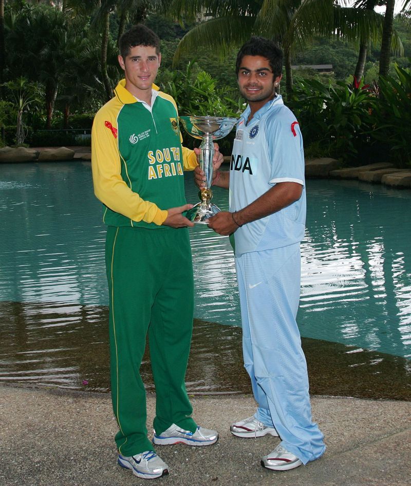 Wayne Parnell and Virat Kohli pose with the U-19 World Cup trophy ahead of the final.