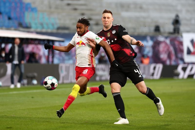 RB Leipzig's Christopher Nkunku battles for the ball with Niklas Sule of Bayern Munich.