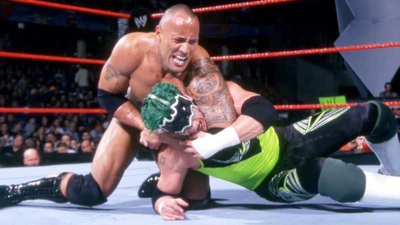 The Rock putting The Hurricane into a headlock.