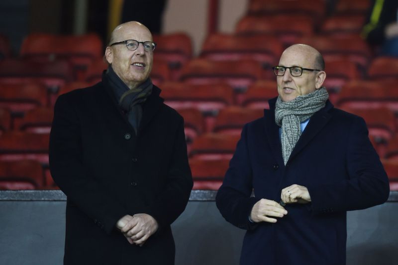 Avram Glazer and Joel Glazer look on