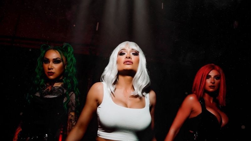 NXT Superstars Scarlett Bordeaux and Shotzi Blackheart, alongside singer Harley Cameron