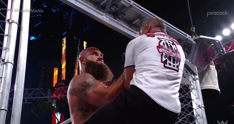 Strowman pulls Shane through the cage