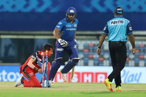 Yuzvendra Chahal of Royal Challengers Bangalore runs out Rohit Sharma