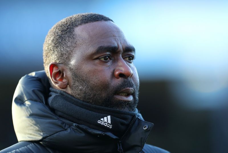 Andy Cole looks on