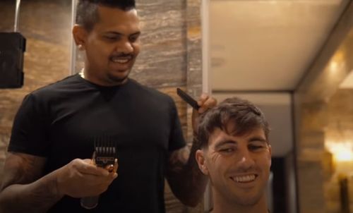 Pat Cummins gets a haircut from Sunil Narine. Pic: Pat Cummins/ YouTube