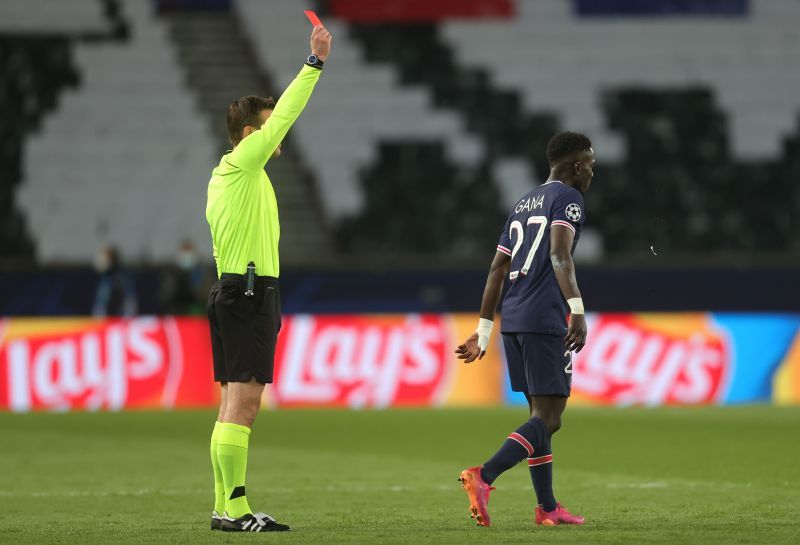 Idrissa Gueye is shown a red card by Referee Felix Brych after a reckless challenge on Gundogan