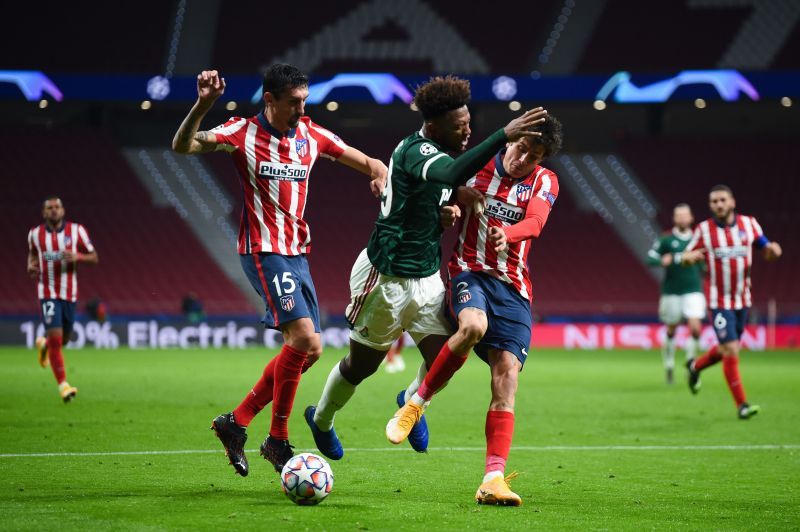 Ze Luis of Lokomotiv Moscow is challenged by Jose Gimenez and Stefan Savic