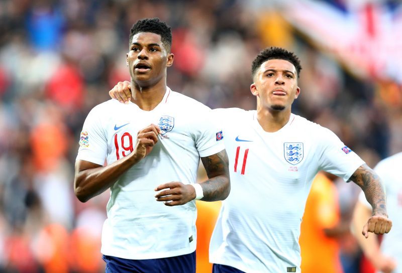 Marcus Rashford and Jadon Sancho celebrate a goal for England.