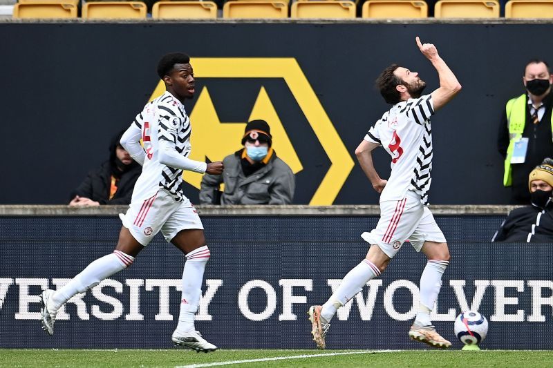 Goals from Anthony Elanga (L) and Juan Mata (R) secured a 2-1 win for Manchester United over Wolves.