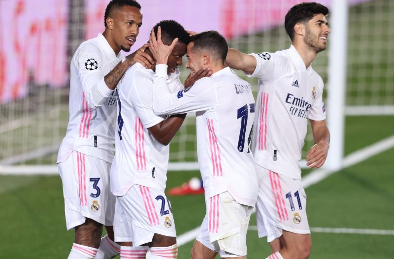 Real Madrid players celebrate a goal against Liverpool