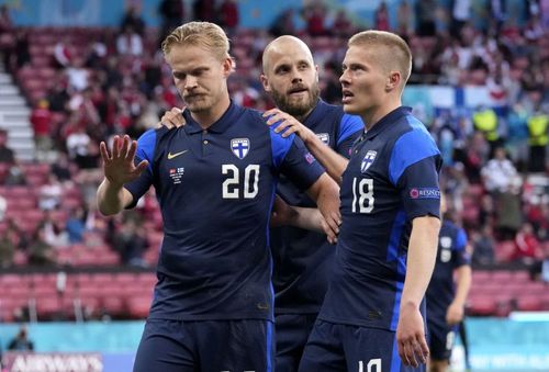 Finland players react after Joel Pohjanpolo's (left) goal against Denmark