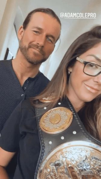 Adam Cole with Britt Baker and the AEW Women's World Championship