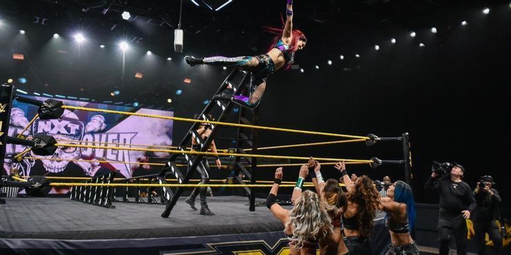 Io Shirai performing a diving crossbody