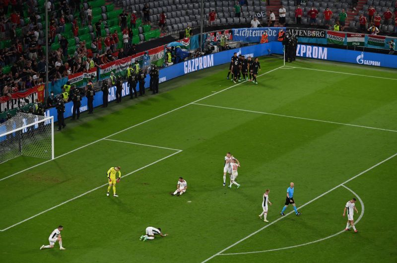 Germany (top centre) celebrate their late equalizer while Hungary players look dejected