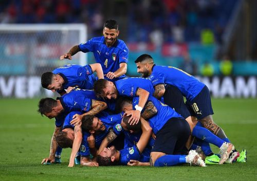 Manuel Locatelli is mobbed after scoring his second goal of the game in Italy's Euro 2020 match