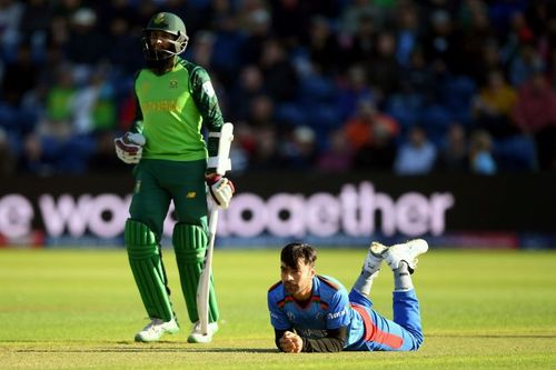 Rashid Khan (in blue) has captained Afghanistan in all three formats