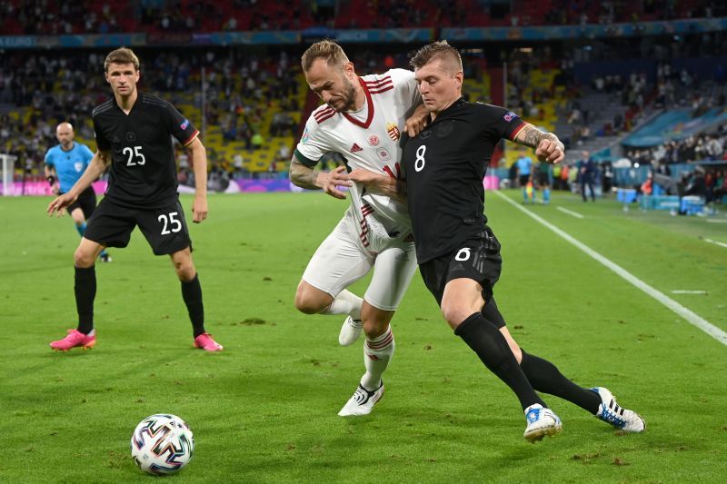 Germany's Toni Kroos tussles it out against Gergo Lovrencsics of Hungary