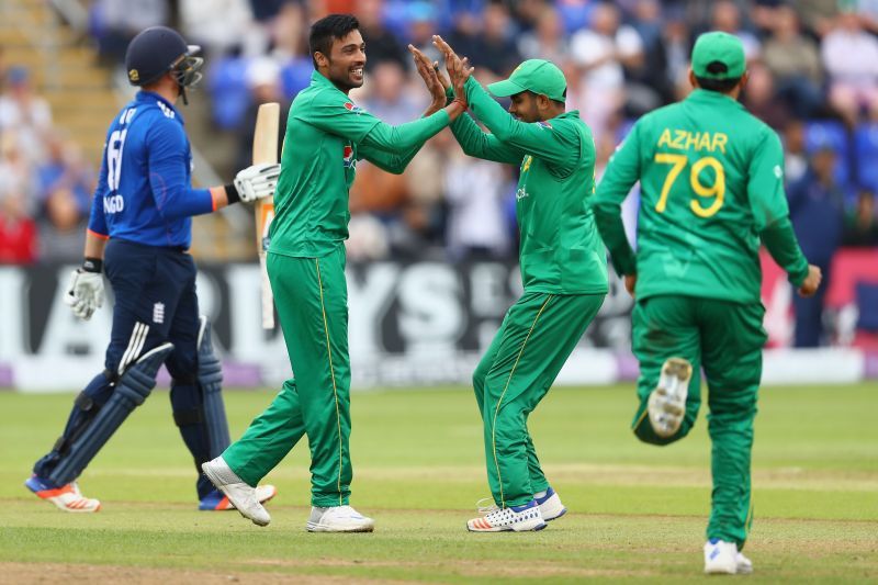 Mohammad Amir (L) celebrating a fall of a wicket with Babar Azam.