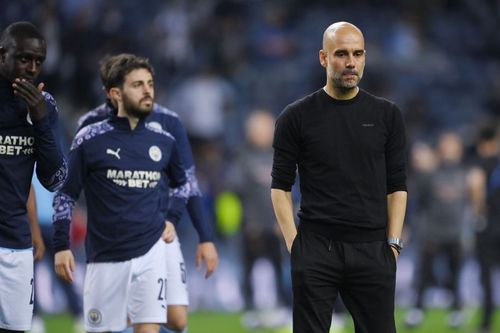 Manchester City manager Pep Guardiola (right) looks on during his side's 2020-21 Champions League final loss to Chelsea