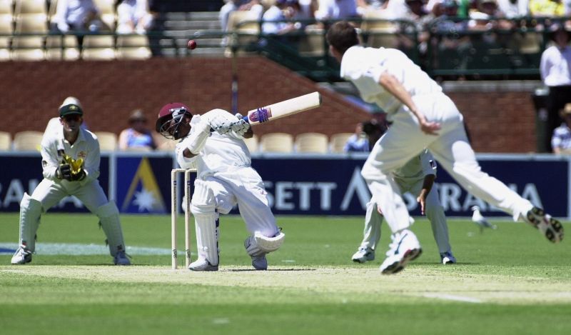 Brian Lara ducks a ball from Glenn McGrath as Adam Gilchrist keeps wicket.