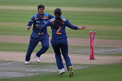 Deepti Sharma and Sneh Rana celebrate a wicket.