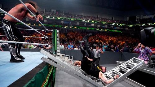 Kevin Owens takes a powerbomb through a ladder