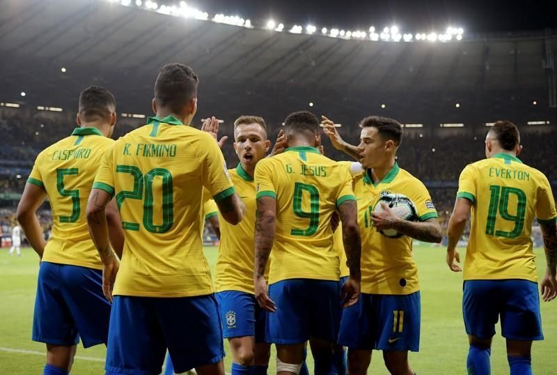Brazil players celebrate one of their two goals against Argentina