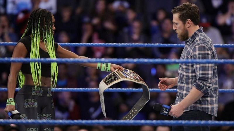 Naomi handing over the SmackDown Women's Championship