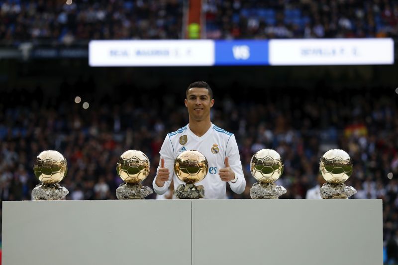 Cristiano Ronaldo poses with his five Ballons d&#039;Or at the Bernabeu