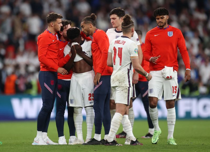 Bukayo Saka being consoled by his team-mates after missing the penalty against Italy