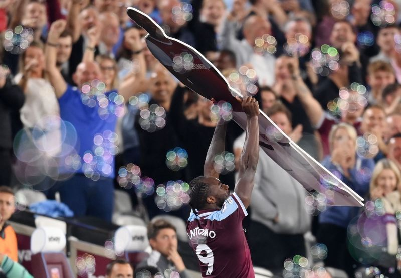 Antonio celebrates with a cardboard cut-out of himself